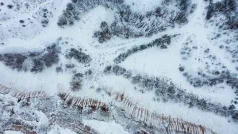 Drone is descending, rotating over a snow-covered old chalk quarry.  Drone ov Stock Footage 219864882