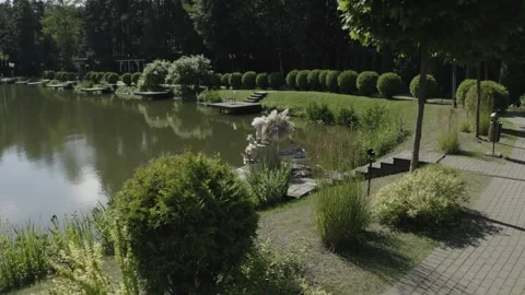 Drone descending toward lakeside installation Stock Footage 329540201