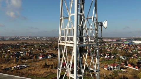 Drone descending vertically beside communication tower Stock Footage 323462502