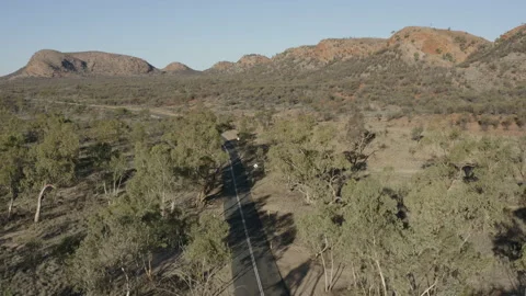 Drone descending to view a road in mountains Stock Footage 191048239