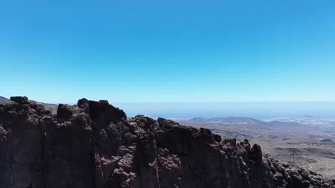 Drone Descends from Coastline to Reveal Dramatic Mountain with Caves Stock Footage 310146115