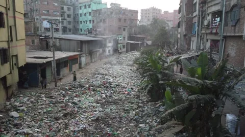 Drone Descends Over Garbage Filled Urban Area Showing People Near Waste in Dhaka Video stock 327272477