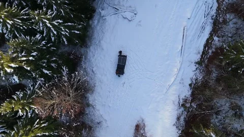Drone descends on solar-powered vehicle on snowy forest road, Haut-Jura 스톡 동영상 336478426