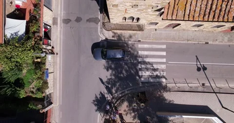 Drone descends while cars turn on road Stock Footage 219968282