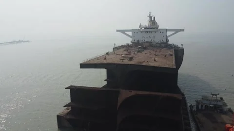 Drone Descent Along Open Front of Dismantled Ship at a Shipbreaking Yard Stock Footage 327197031