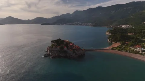 Drone Descent and Parallax over Sveti Stefan Resort at Golden Hour, 4K Stock Footage 337179633