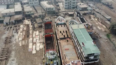 Drone Descent Over Beached Ships and Shipyard with Workers Along Buriganga River Video stock 327265842