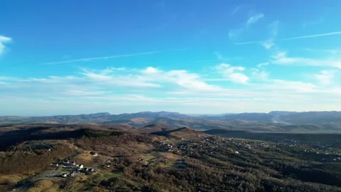 Drone Descent Over Forested Landscape with Village Views Stock Footage 299711053