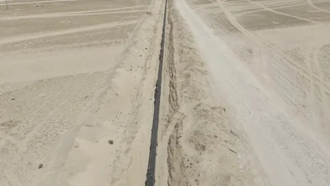 Drone Descent Over Long Pipeline Construction Corridor in Saudi Arabia Stock Footage 344824226