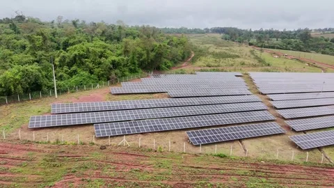 Drone Descent Over Solar Panels With Medium-Voltage Cabin on Cloudy Day Stock Footage 321568478