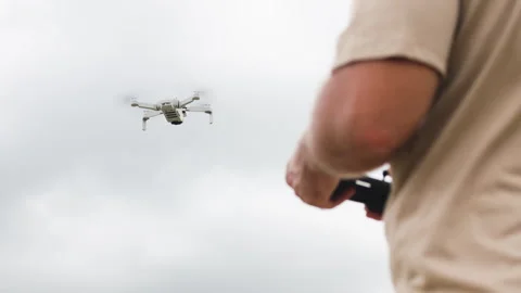 Drone development engineer tests new model in field. Tester deftly operates Stock Footage 322041776