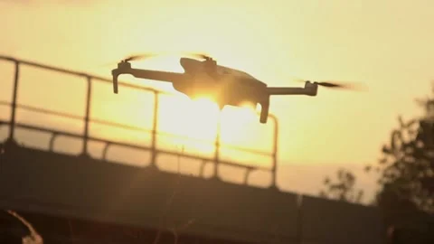 Drone device that flies in the afternoon, UAV, aerial drone Stock Footage 292904275
