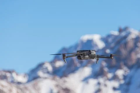 Drone with digital camera flying over winter landscape with snow covered mo.. Stock Photos