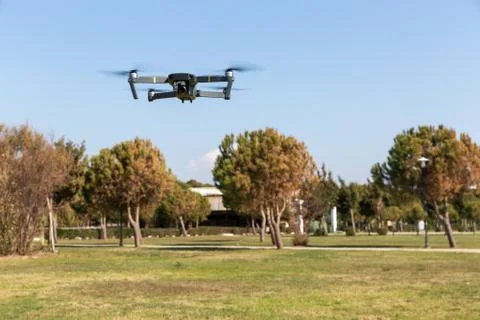 A drone with digital camera flying in the park Фото