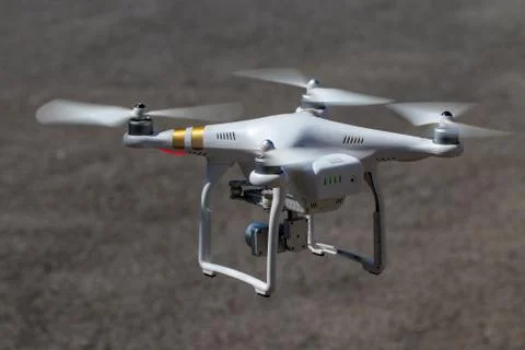 Drone with digital camera on the road background Stock Photos