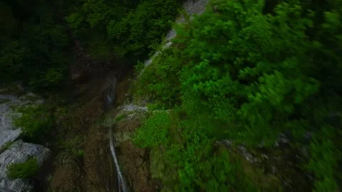 Drone dive from narrow waterfall Stock Footage 279062043