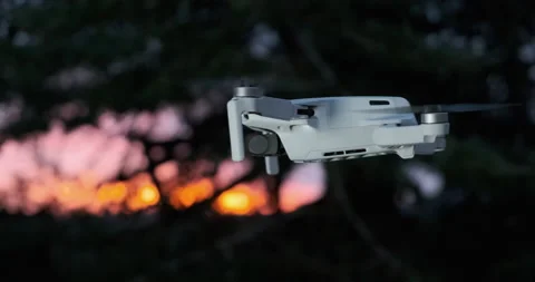 Drone DJI Mavic Mini accelerating into the sun Stock Footage 175673392