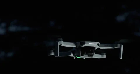 Drone DJI Mavic Mini rotating with underlight creating contrast / Broll Stock Footage 175674687