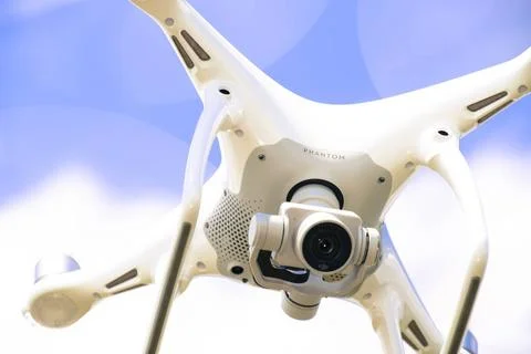 Drone DJI Phantom 4 in flight. Quadrocopter against the blue sky Krasnodar... Stock Photos