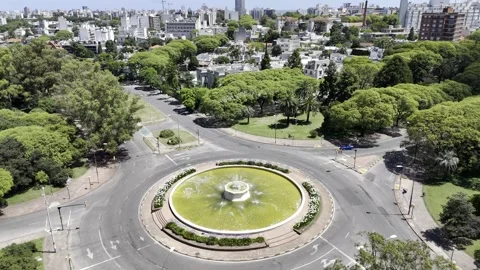 Drone does 360 around the Fuente Iluminada on sunny day in Montevideo Stock Footage 297886336