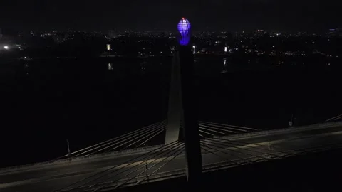 Drone does 360 at night around tanzanite gem in middle of bridge Stock Footage 342254624
