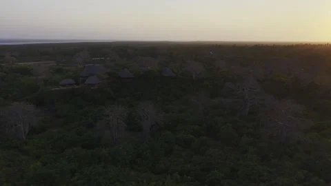 Drone does wide orbit around restaurant and lodge on a hill overlooking forest Stock Footage 344141572