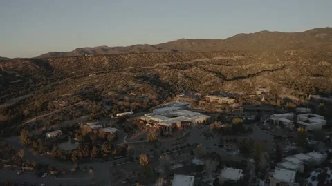 Drone dolly back while tilting up from snowy west town to New Mexico landscape Stock-Footage 167672219