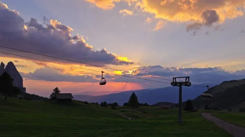 Drone Dolly Out Revealing Cable Cars at Sunset Over Alpe di Siusi and Dolomites Stock Footage 346774504
