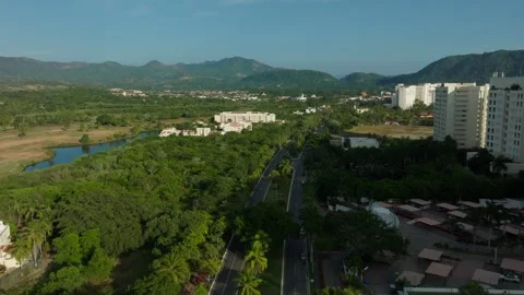 DRONE: DOLLY IN SHOT OF THE MAIN BOULEVARD IN IXTAPA ZIHUATANEJO AT SUNSET Stock Footage 323416940