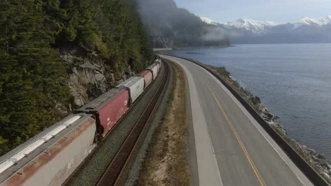 Drone dolly shot over CN Rail grain train along the Skeena River 4K Stock Footage 149147136