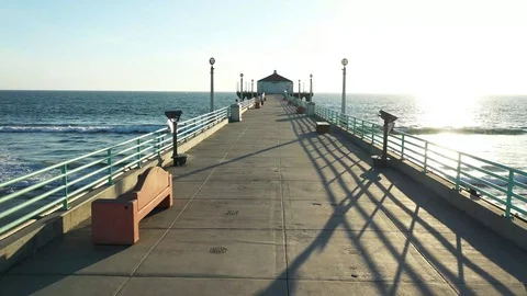 Drone down empty beach pier at sunset during Corona Virus Pandemic Video stock 127610245