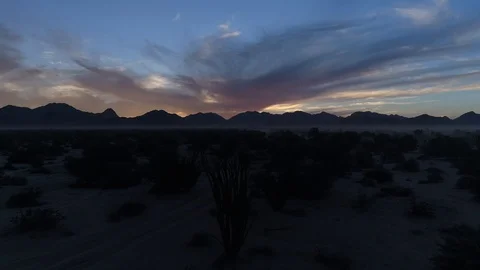 Drone dramatic backlit mountain at sunrise Stock Footage 104884044