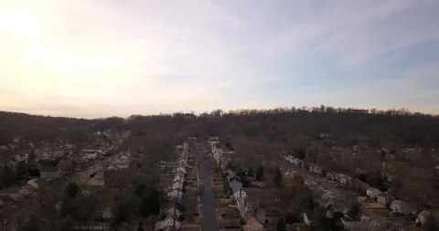 Drone drifting left to right over housing development dusk Video stock 125037544