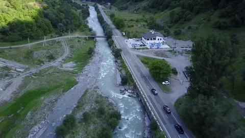 Drone driving car, Tsminda Sameba Gergeti Georgia Europe mountains cows Stock Footage 81379966