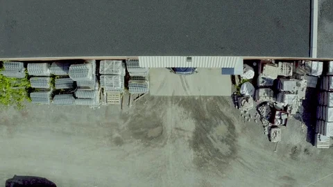 Drone drop-down on truck exiting metal factory with load Stock Footage 124227858