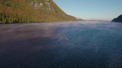 Drone Epic Wide Man Paddles Yellow Raft Over Fog Covered Lake Stock Footage 255752870