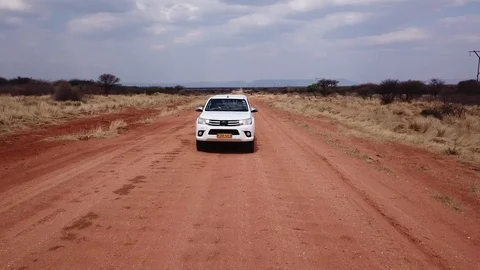 Drone establishing shot running car, Namibia streets, Africa in 4K Stock Footage 90802342