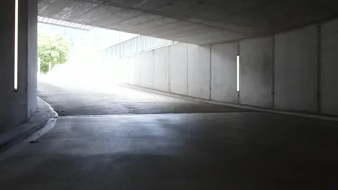 Drone exit from underground garage with alpine backdrop Stock Footage 331845327