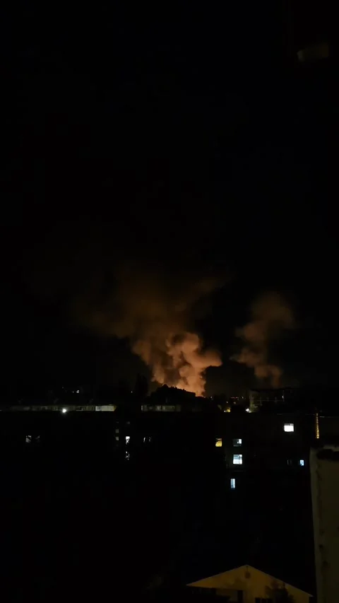 Drone explosion fire smoke and car alarm in night city with audio Video stock 317687792