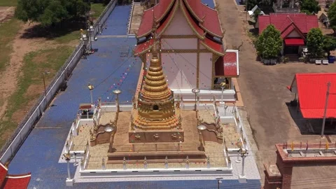 Drone fast orbit shot of a golden chedi at a Buddhist temple complex Stock Footage 335806086