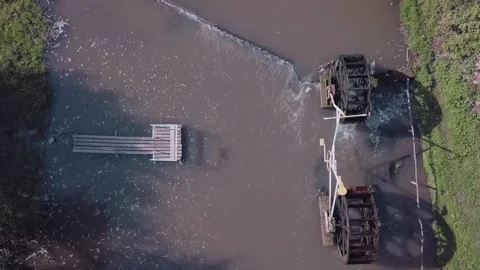 The drone is filmed over the river on which there is a water mill, a pier and a Stock Footage 151079693