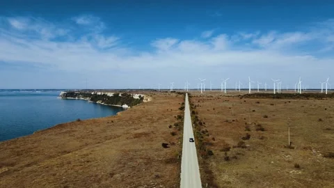 Drone filming car driving on a road in Bulgaria along Cape Kalikra and numerous Stock Footage 219626133