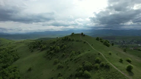Drone filming over green hills Stock Footage
