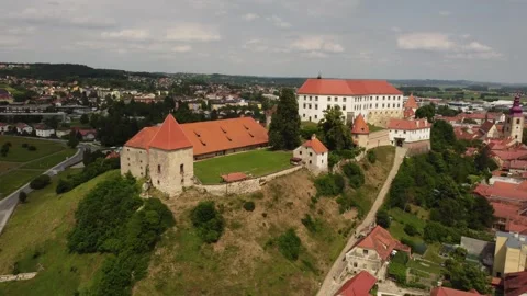 A drone films an ancient castle located on a hill. The drone moves backward Stock Footage 266168091