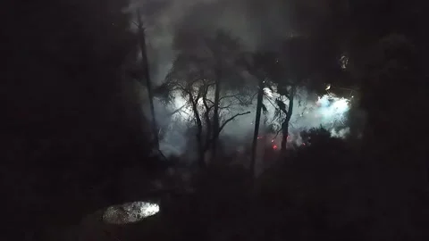 Drone: Fire Crew Fights Wind Driven Brush Fire at Night Stock Footage 327577072