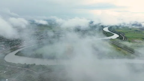 Drone flew through clouds. River, green fields, houses and clouds Video stock 280344271