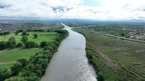 Drone flew through clouds. River, green fields, houses and clouds Stock Footage 280344373