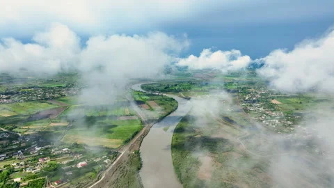 Drone flew through clouds. River, green fields, houses and clouds Stock Footage 280344957
