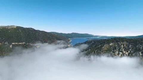 Drone flies above the clouds filming Big Bear Lake in California, USA Video stock 138641896