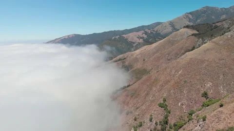Drone flies above clouds towards mountains in Big Sur California Stock Footage 142298108